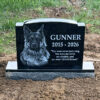 Gunner’s custom black granite dog memorial with engraved portrait and tribute quote on his family farm
