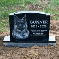 Gunnerโs custom black granite dog memorial with engraved portrait and tribute quote on his family farm