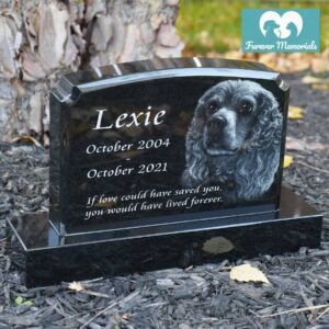 Polished black granite upright pet memorial engraved with a detailed portrait of Lexie the dog, including the inscription “If love could have saved you, you would have lived forever” and the dates October 2004 – October 2021.