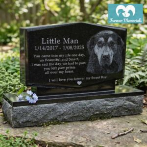 Custom engraved black granite upright pet memorial for dog Little Man with detailed portrait engraving and memorial poem, displayed in a natural garden setting