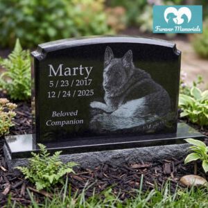 Black granite pet memorial headstone for Marty (May 23, 2017 – Dec. 24, 2025) engraved with a detailed portrait of a German Shepherd, displayed in a peaceful backyard garden setting.