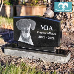 Custom engraved black granite upright pet memorial for dog Mia with detailed portrait engraving and inscription “Forever Missed 2021–2024,” displayed in an outdoor garden