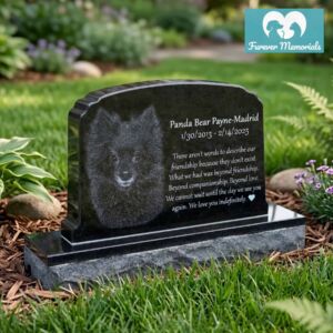 Custom engraved black granite upright pet memorial for dog Panda Bear Payne-Madrid with detailed portrait engraving and inscription, placed in a landscaped garden