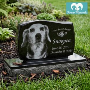 Custom engraved black granite upright pet memorial for dog Snoopea with detailed portrait engraving and inscription “Our Sweet Angel,” displayed in a landscaped garden
