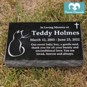 Black granite pet memorial marker engraved for Teddy Holmes with a cat silhouette, cross symbol, and inscription “In Loving Memory of Teddy Holmes, March 12, 2003 – June 23, 2022.”